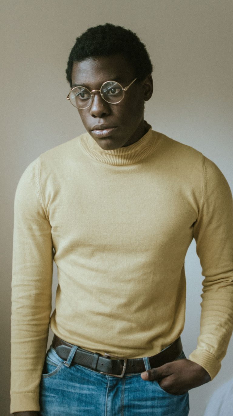 Man in business attire wearing thin metal frame glasses, showcasing the affordable eyewear selection at Msimbazi Eyes and Vision Care in Dar es Salaam