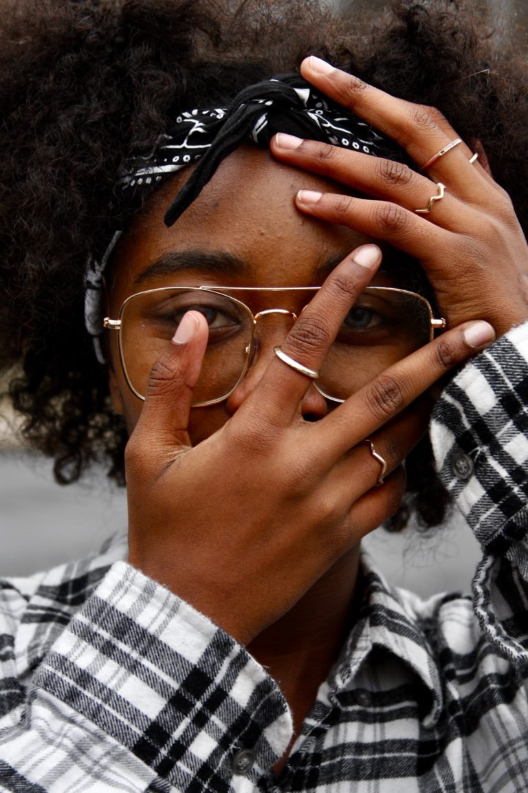 Young woman wearing stylish round tortoiseshell glasses, part of Msimbazi Eyes and Vision Cares' fashion collection in Dar es Salaam